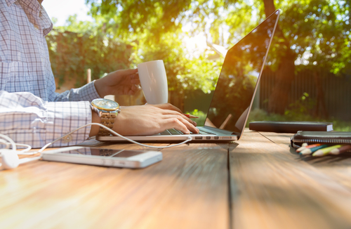 Man working outside on laptop.