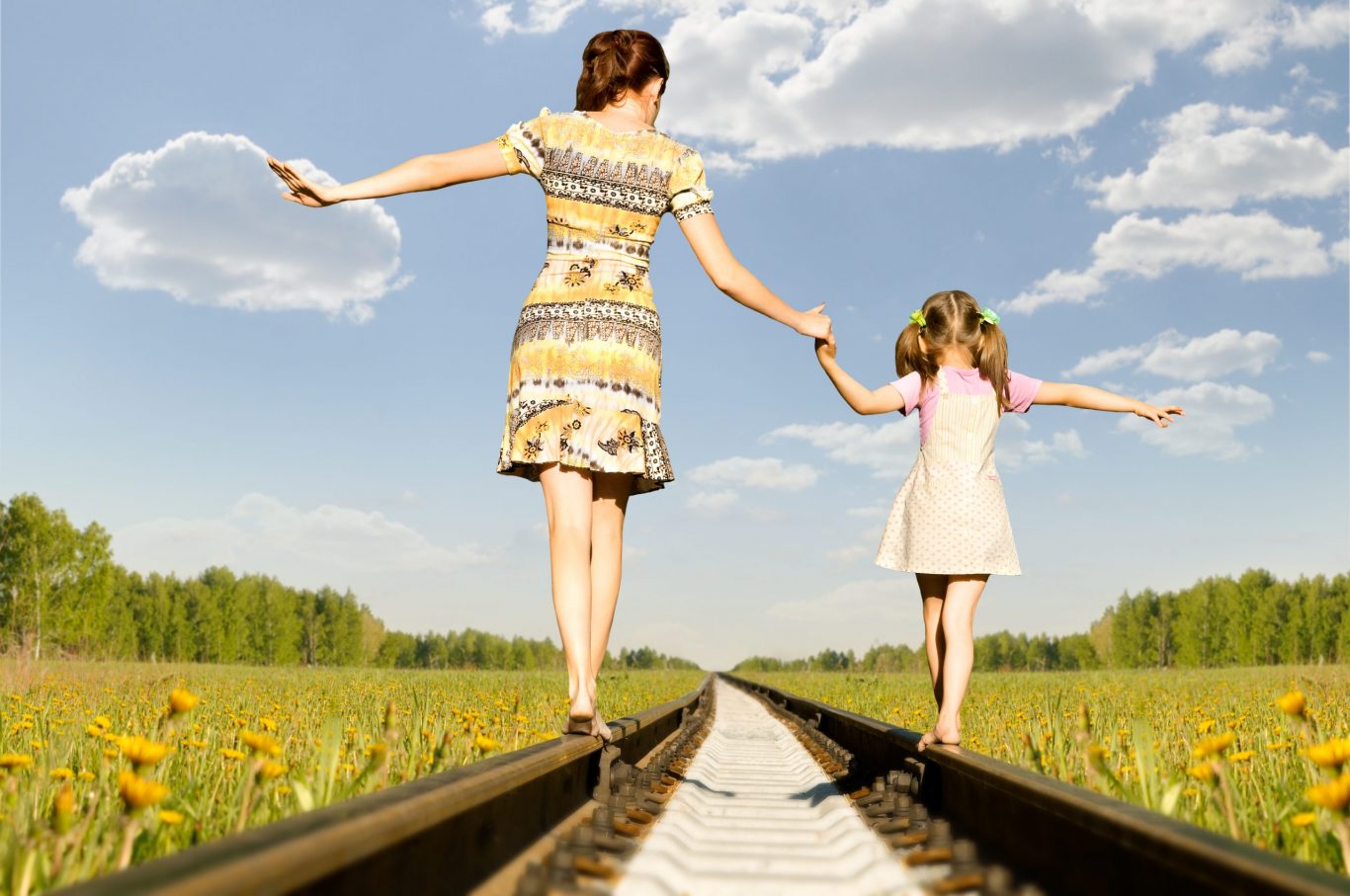 Balance with daughter on train tracks