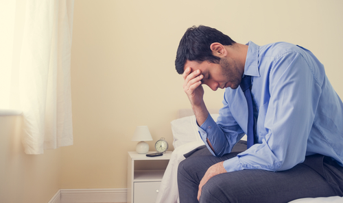 Depressed Man with Head in Hands